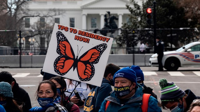 Activists march toward the White House on Feb. 23 in a call for Congress and the Biden administration to pass legislation granting immigrants with Temporary Protected Status a path to citizenship.